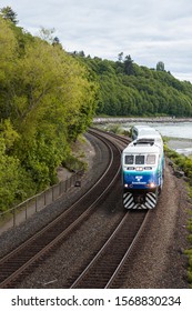 Seattle, WA / USA - 19 May 2017: A Sound Transit Train Passes Under The Pedestrian Overpass At Carkeek Park