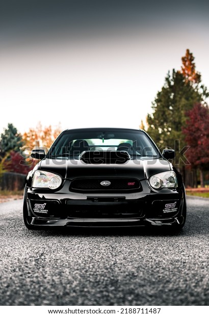 Seattle, WA, USA\
April 19,\
2022\
Black Subaru STI showing the front of the car and the hood\
scoop