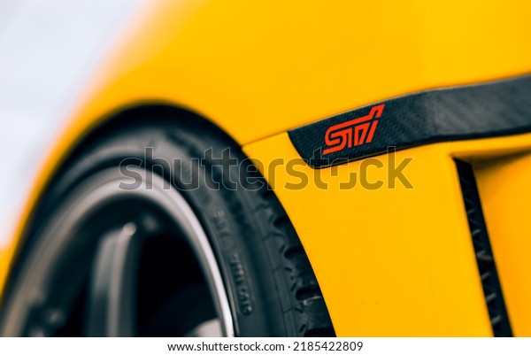Seattle, WA, USA\
August 1,\
2022\
Yellow Subaru STI with a carbon fiber STI logo on the\
fender