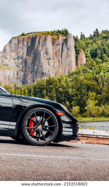 Seattle, WA, USA\
August 12, 2022\
Porsche 911\
Carrera S in black parked showing the front of the car with a\
mountain in the\
background