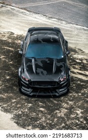 Seattle, WA, USA
August 18, 2022
Widebody Ford Mustang With A Camouflage Vinyl Wrap Parked And Viewed From Above