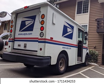 Seattle, WA / USA - Circa April 2020: Street View Of A USPS Mail Truck In A Seattle Area Neighborhood, Delivering Mail During The COVID-19 Pandemic.