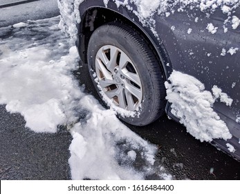 Seattle, WA / USA - Circa January 2020: Focus On An All Wheel Drive Car Tire Surrounded By Sleet And Snow And Ice After A Pacific Northwest Snowstorm.