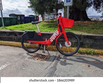 Seattle, WA USA - Circa June 2020: Jump By Uber Ride Share Bikes Lined Up By A Metal Chain Link Fence Downtown.