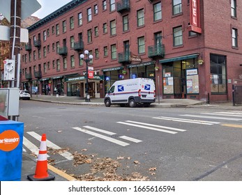 Seattle, WA / USA - Circa November 2019: Local USPS Mail Carrier Van Making Its Deliveries In Downtown Seattle On A Saturday Afternoon.