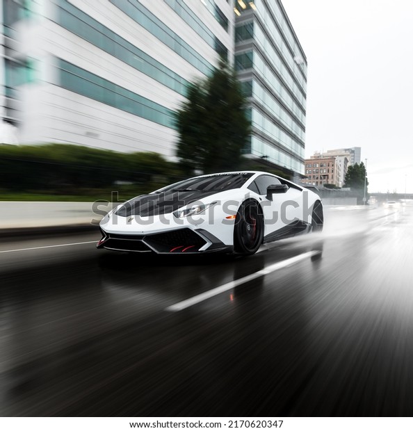 Seattle, WA, USA\
Feb 19,\
2022\
Lamborghini Huracan driving in the rain with water spray\
behind the car