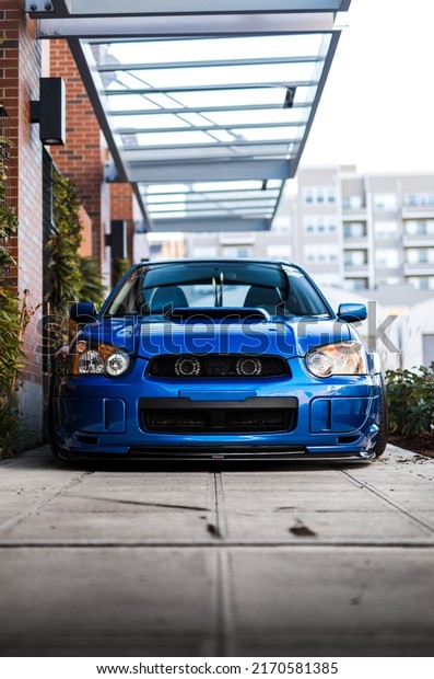 Seattle, WA, USA\
Feb 2, 2022\
Blue\
Subaru WRX parked showing the front grille of the\
car