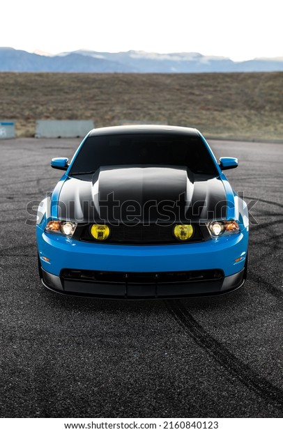 Seattle, WA, USA\
Feb. 9, 2020\
Blue Mustang with a\
black hood parked on a\
road