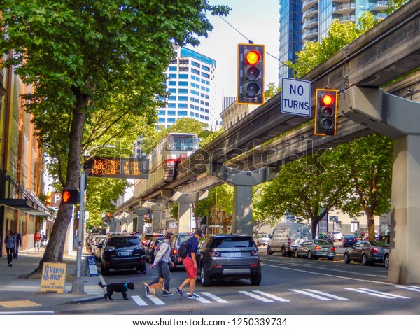 SEATTLE, WA, USA - JUNE 2018:\
Monorail running on an elevated track above a street in downtown\
Seattle.