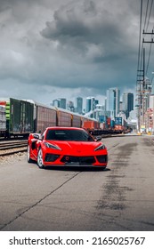 Seattle, WA, USA
June 4, 2022
Red Corvette C8 Stingray Parked Next To A Train Rail Line