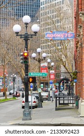 Seattle, WA, USA - March 06, 2022; 1st Avenue South In The Pioneer Square Neighborhood Of Seattle, Historic Street Light Fixtures And Neon Sign Of State Hotel Rooms 75 Cents