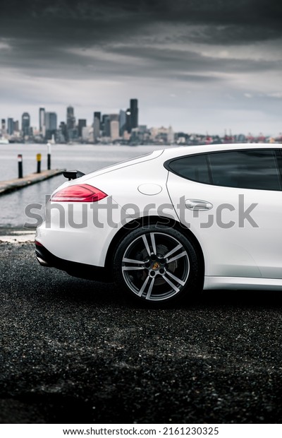 Seattle, WA, USA\
Nov 5,\
2021\
White Porsche Panamera parked with the city of Seattle in the\
background