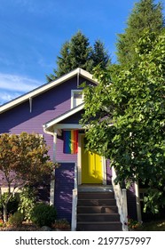 Seattle, WA USA - Sept 15 2021: A Pride Flag Is Displayed On A Purple House With A Yellow Door