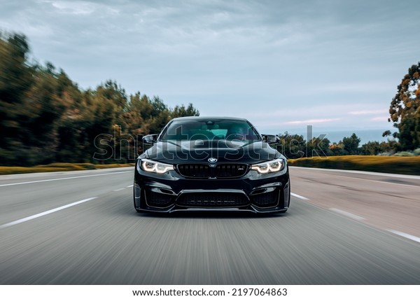 Seattle, WA, USA\
September 1,\
2022\
BMW M4 driving on the street showing the front of the\
car