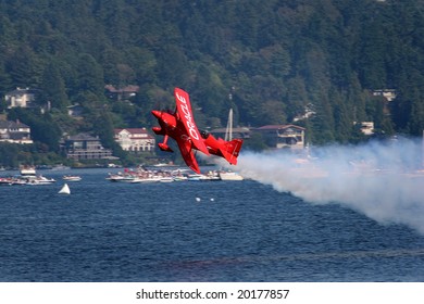 Seattle WA-August 4: Oracle's Red acrobatic stunt plane shows off it's moves at Seafair. August 4 2007 Lake Washington.