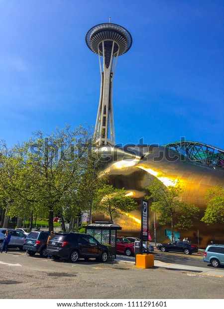 Seattle, Wash / April 16, 2016: Seattle Space\
Needle,It is an observation tower in Seattle, Washington, a\
landmark of the Pacific Northwest, and an icon of Seattle. View\
from the street. Cars\
parked.