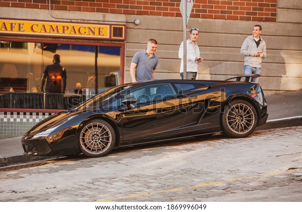 Seattle,
Washington - May 08, 2009:Three young men stop to gawk at exotic
car parked on the street awe car
Ferrari