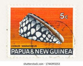 SEATTLE WASHINGTON - May 25, 2020:  Marbled Cone Snail On Papua And New Guniea 5 Cent Stamp. Scott # 268