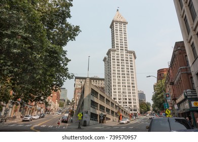 SEATTLE, WASHINGTON - SEPT. 1, 2017: Smith Tower, oldest skyscraper in city, was built in 1914. "Sinking ship" parking garage, foreground, was built in 1961 when historic Seattle Hotel was demolished.