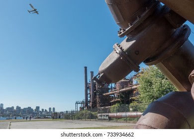 SEATTLE, WASHINGTON - SEPT. 2017: Seattle Skyline, Seaplane Above, Remnants Of Last Coal Gasification Plant In US At Seattle's Gas Works Park On Lake Union. 