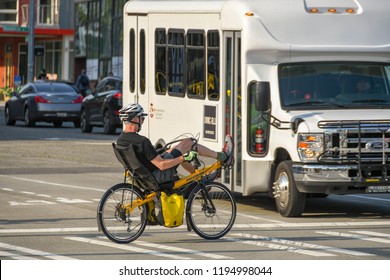 SEATTLE, WASHINGTON STATE, USA - JUNE 2018: Person Cycling To Work On An Unusual Bike On A Street In Downtown Seattle.