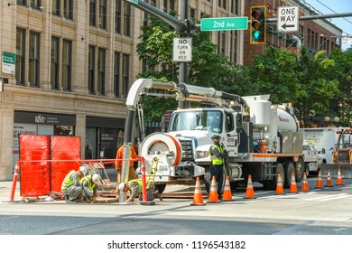 SEATTLE, WASHINGTON STATE, USA - JUNE 2018: Road works and construction operatives on a street in Seattle city centre.