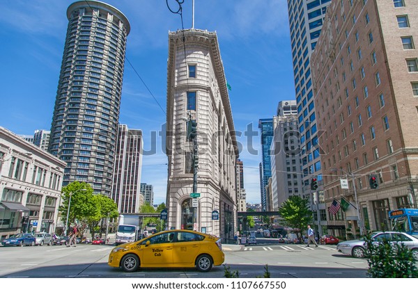 SEATTLE, WASHINGTON,\
USA - APRIL 15,2015 : Beautiful architecture of old building and\
yellow taxi in downtown Seattle,This is a famous place in Seattle\
,Washington state USA.