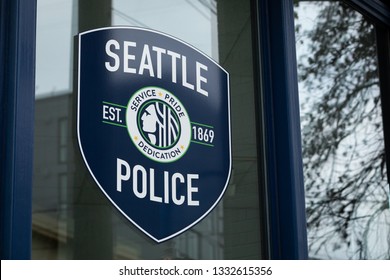 Seattle, Washington / USA - February 27 2019: Badge logo for the Seattle Police Department, on the window of the Capitol Hill Precinct station, with space for text on the right