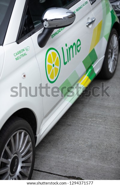 Seattle, Washington / USA - January 21 2019: Lime\
logo on the driver door of a LimePod car-share, with space for text\
on the bottom