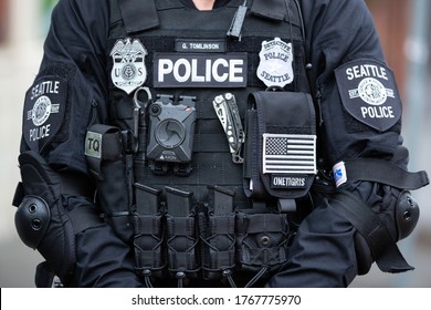 Seattle, Washington / USA - July 1 2020: Axon body camera faceless Seattle Police Detective standing with a riot stick