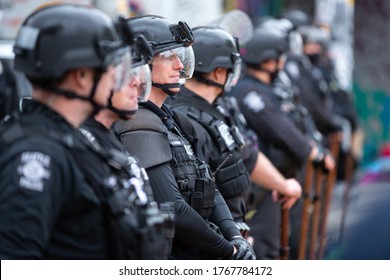 Seattle, Washington / USA - July 1 2020: Line Of Seattle Police Officers With Riot Sticks, Blocking Access To The Capitol Hill Occupation Protest (CHOP)