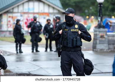 Seattle, Washington / USA - July 1 2020: Seattle Police Standing Watch At Cal Anderson Park While Clearing The Capitol Hill Occupation Protest (CHOP)