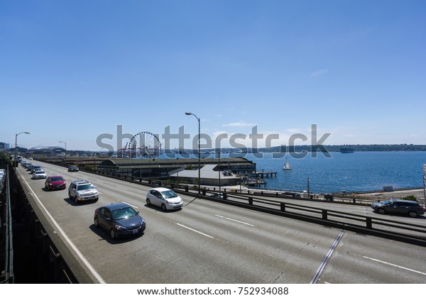 Seattle, Washington, USA - July 2,2017 :\
Cars on Alaskan Way Viaduct with Puget Sound background (An inlet\
of the Pacific Ocean), Seattle, Washington,\
USA