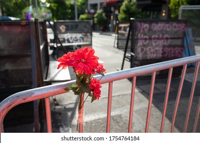 Seattle, Washington / USA - June 10 2020: Flowers On A Barricade At The Entrance To The Capitol Hill Autonomous Zone (CHAZ)