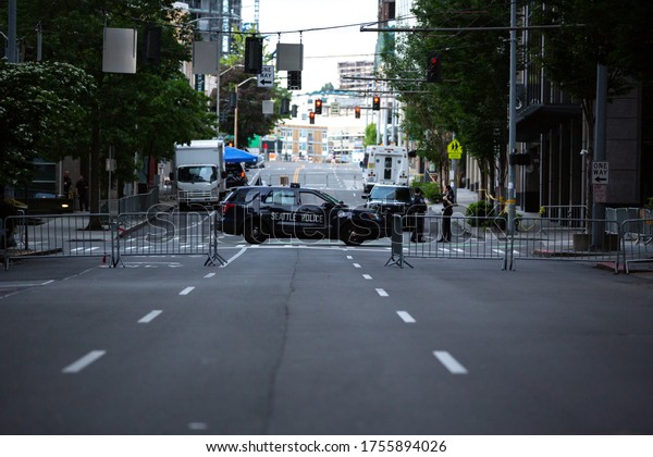 Seattle, Washington / USA - June 10 2020: Squad\
car blocking 9th Avenue in front of the Seattle Police Department\
West Precinct