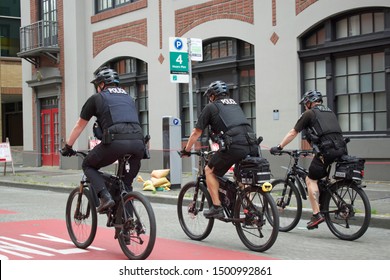 SEATTLE, WASHINGTON USA JUNE 16, 2019: Seattle Policemen in uniform patrolling the streets of Seattle on bicycle, Seattle, Washington, June 16, 2019