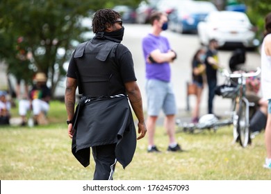 Seattle, Washington / USA - June 19 2020: Man Walking With A Bullet Proof Vest During A Peaceful Juneteenth Rally At Judkins Park In Seattle