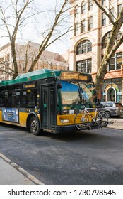 Seattle, Washington, USA. March 2020. A Bus Carrying A Bicycle In The Outer Trunk In Pioneer Square