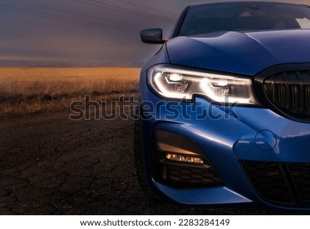 Seattle, Washington, USA March 31, 2023 blue BMW 3 car with M Performance package. Close-up of the headlights of a modern car while turning on the light