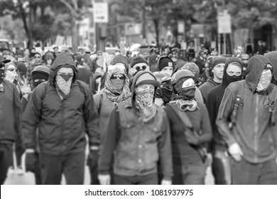 Seattle, Washington USA May 1st 2018 The Annual May Day Protests Held Downtown, Violent Antifa Members Marching With Masks Covering Their Faces In Black And White.