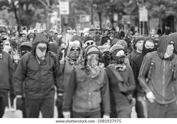 Seattle, Washington USA May 1st 2018 The annual May Day protests held downtown, violent Antifa members marching with masks covering their faces in black and white.
