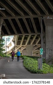 Seattle, Washington / USA - May 21 2020: Couple Walking On A Trail Under The West Seattle Bridge