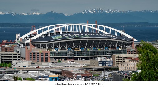 Seattle, Washington/U.S.A. 05-14-2019 Century Link Field with the Olympic Mountains and surrounding industrial area.
