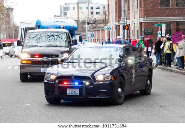 Seattle, Washington/USA/\
January 20, 2018  Woman March. Police vehicles bring up the end of\
the protest.