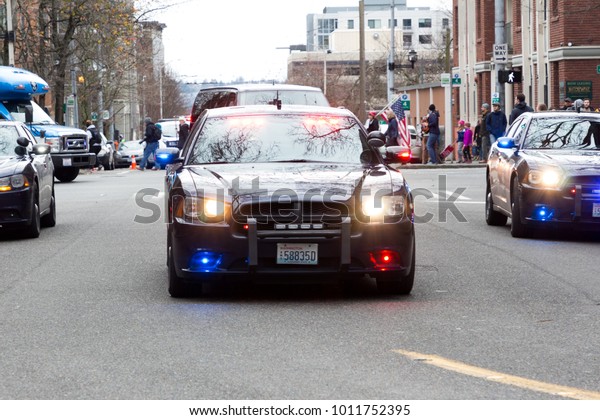 Seattle, Washington/USA\
- January 20, 2018: Woman March. Police vehicles bring up the end\
of the protest.