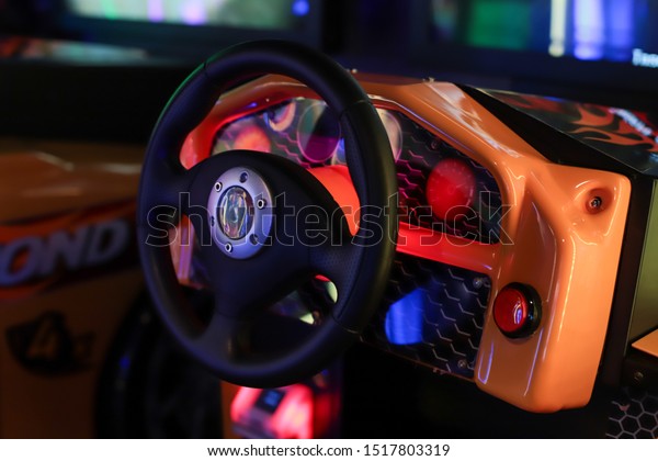 Seattle, Washington/USA - September 29, \
2019 - Close up of car driving machine steering wheel at arcade\
games store. Blurred background. Selective\
focus