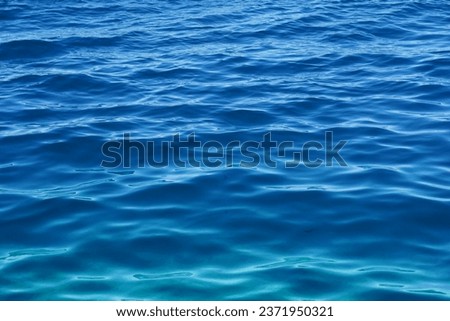 Seawater surface with small waves and gradient blue colors tone