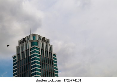 SEC Building, Bangkok/Thailand, May/10/2020: A Bird Is Flying Around The Building On Cloudy Day During Summer.