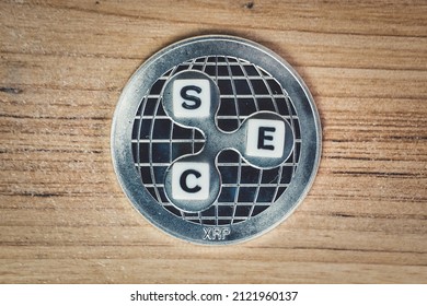 SEC versus ripple, ripple XRP coin + white dices - Shutterstock ID 2121960137