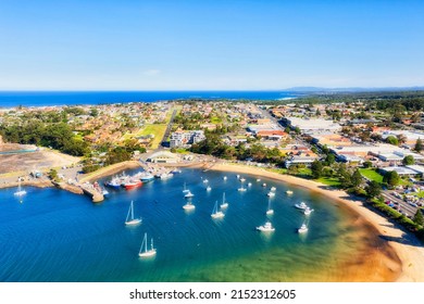 Secluded breakwall protected harbour on Sapphire coast of Australia in Ulladulla town - aerial elevated view over downtown waterfront. - Shutterstock ID 2152312605